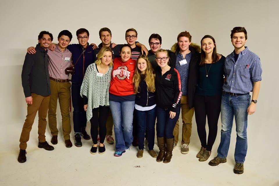 Students hug and pose